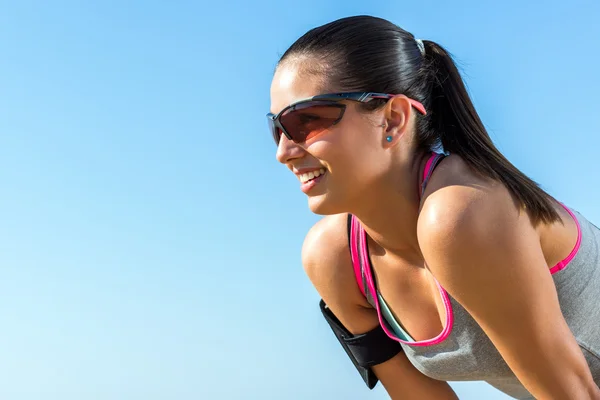 Sportlerin vor blauem Himmel. — Stockfoto