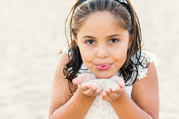 Girl blowing sand. — Stock Photo, Image