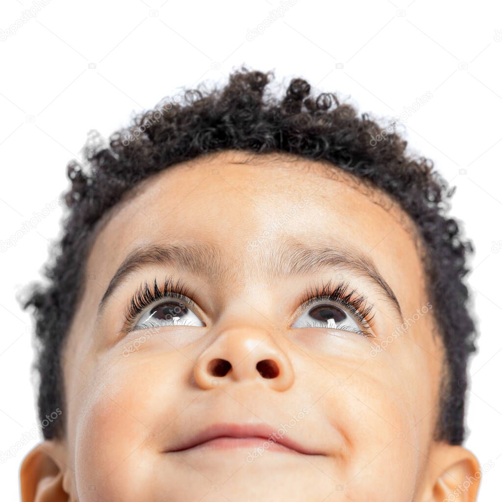 Macro close up portrait of cute little afro american boy looking up. Isolated on white background.