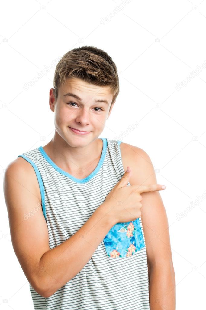 Attractive teen boy pointing aside with finger.