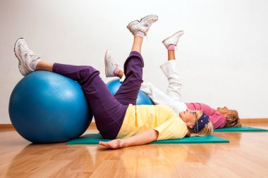 Senior women working out with fitness balls. clipart