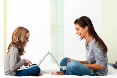 Birlikte evde dizüstü bilgisayarlarda çalışan öğrenciler.