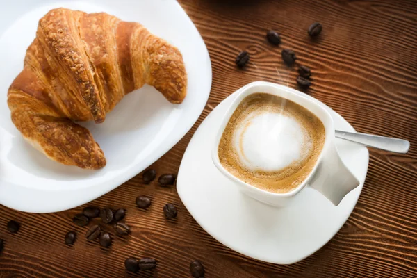 Top view of cappuccino coffee with croissant. — Stock Photo, Image