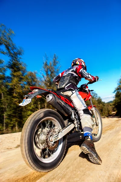 Fast moving motocross rider on dirt road. — Stock Photo, Image