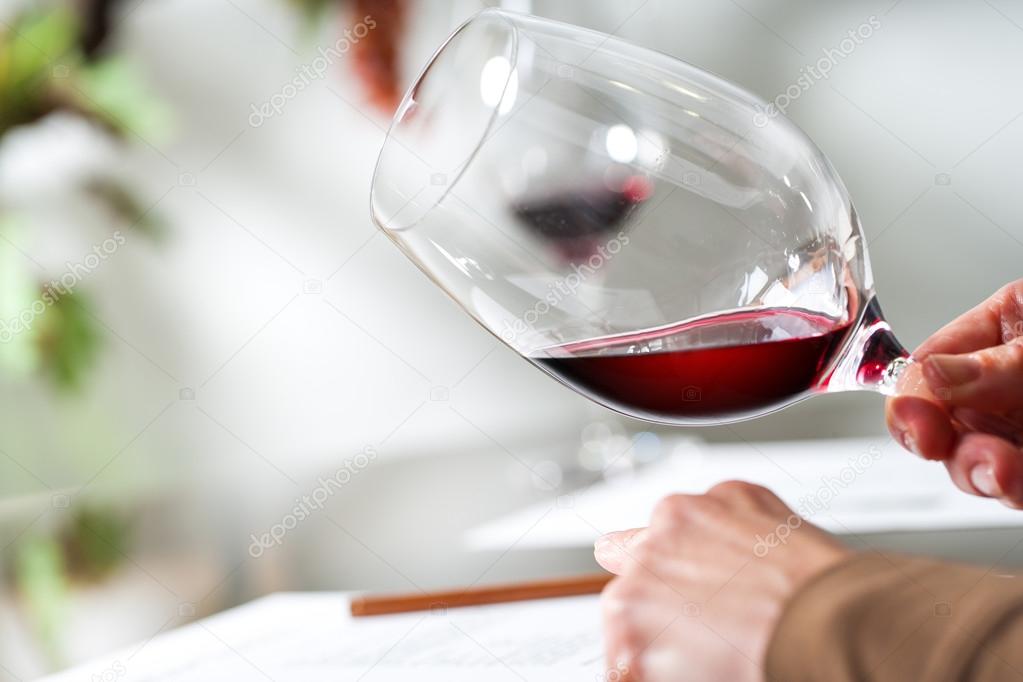 Sommelier evaluating wine at tasting.