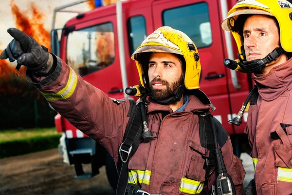 Firemen about to take action. — Stock Photo, Image