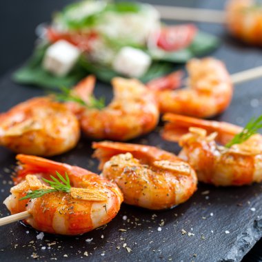 Shrimp tails grilled on wood skewer. clipart