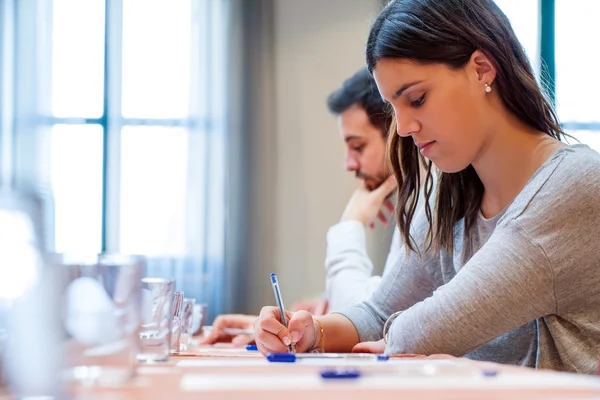 Studenten aan het werk in de vergaderruimte. Stockfoto