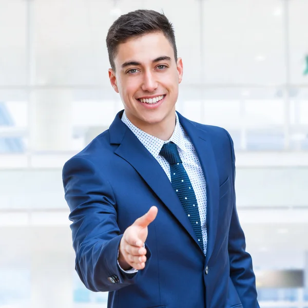 Businessman in suite reaching out hand. — Stock Photo, Image