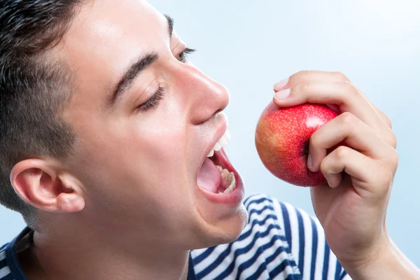 Man about to bite apple. Royalty Free Stock Photos