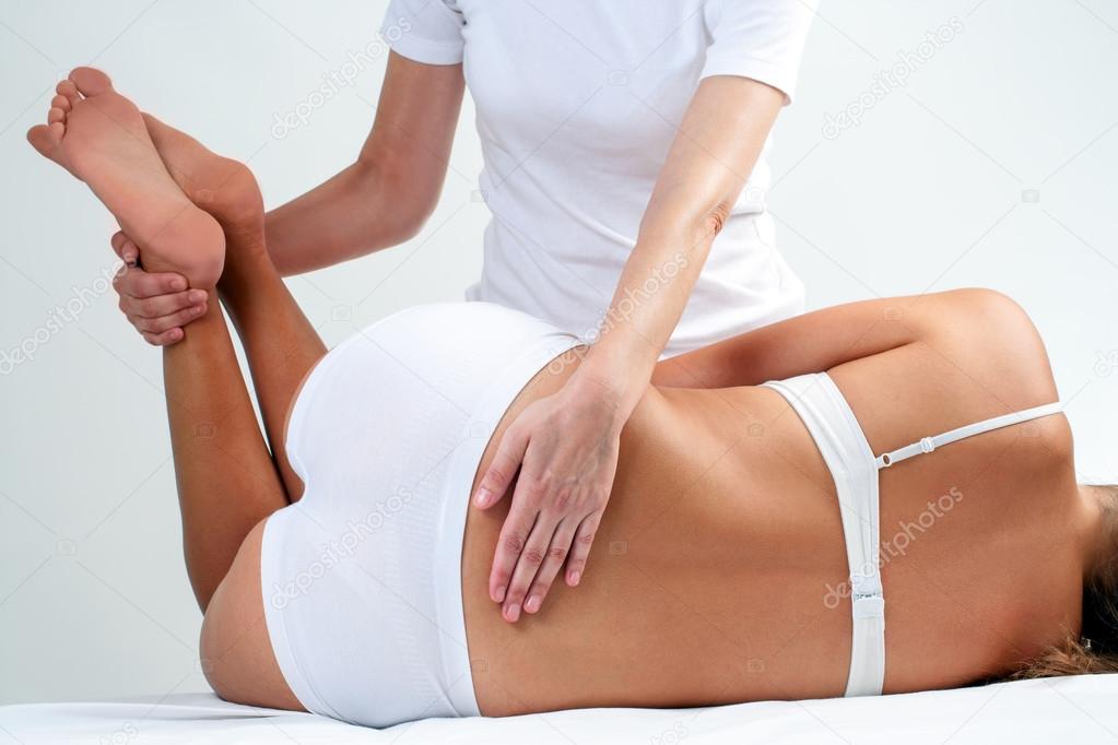 Therapist doing lower back massage