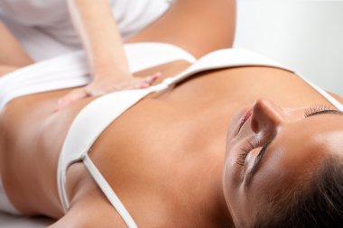 Woman at osteopathic massage clipart