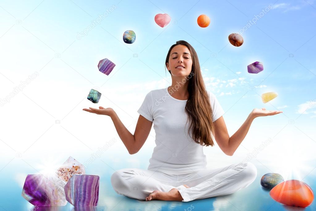 woman doing yoga with precious gemstones