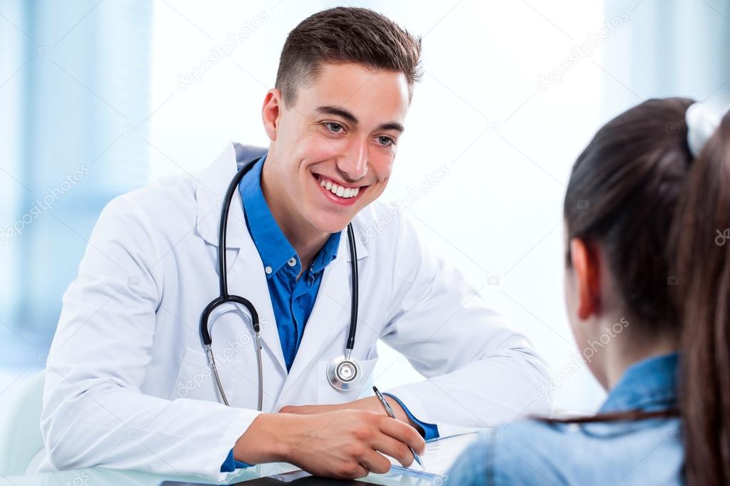 doctor writing prescription to patient