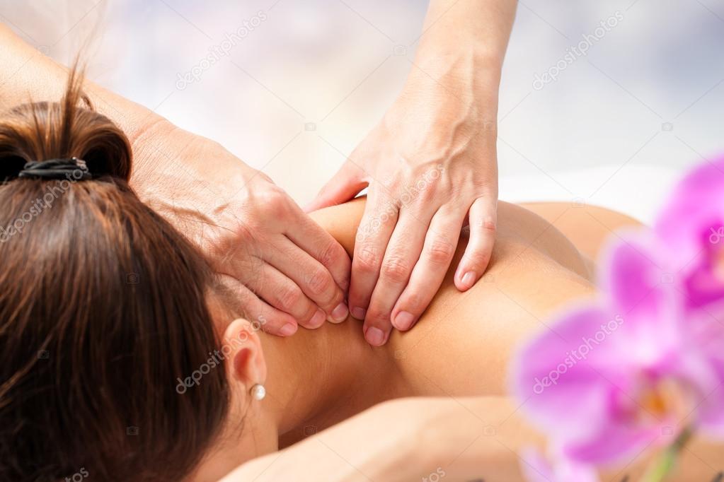 hands massaging female neck