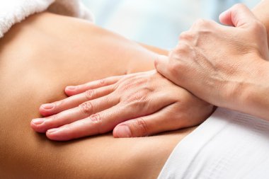 Osteopathic belly massage. clipart