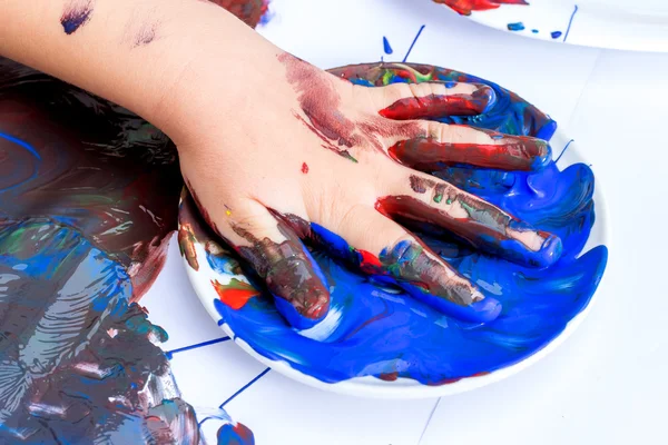 Kid painted hands at table. — Stock Photo, Image