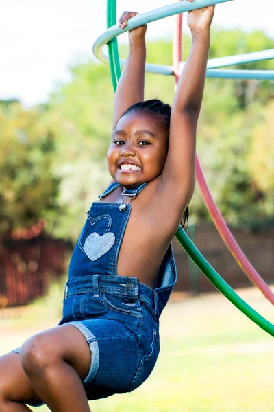 Cute african girl laying on green grass — Stock Photo, Image