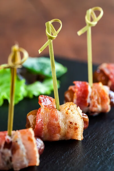 Dates with bacon appetizers. — Stock Photo, Image