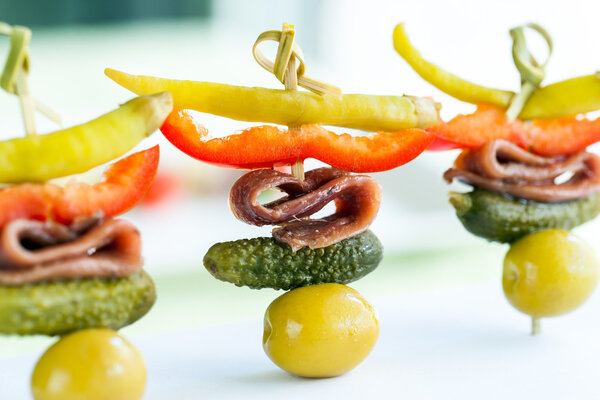 Mini pickled pepper and anchovy appetizer.