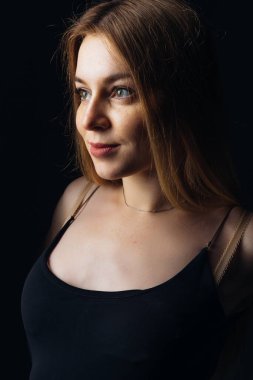 Siyah yazlık bluzlu genç kız. Güzel elbiseli bir sarışın. Şefkatli ve şehvetli görünüyordu. Akşam ya da kokteyl elbisesi.