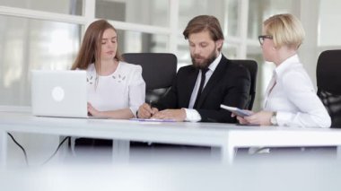 Proje takım çalışmasını tartışan üç meslektaşım var. Adam şirket ekibindeki meslektaşlarına işi anlatıyor. İşbirliği yapıyor, ofiste konuşuyor.