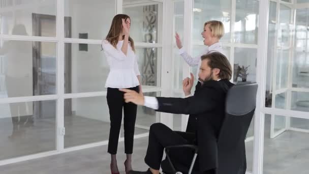 Merry Leader Man Spins His Chair Rejoicing Success Two Girls — Stock Video