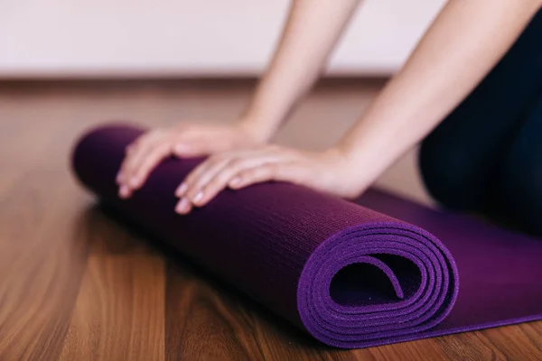 Woman holding a yoga mat in exercise class for a sport and healthy concept