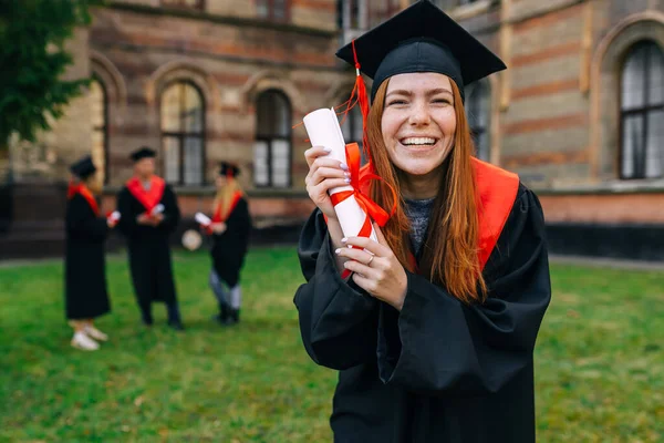 Menina Graduada Alegre Vestido Acadêmico Mostra Pergaminho Com Uma Fita — Fotografia de Stock