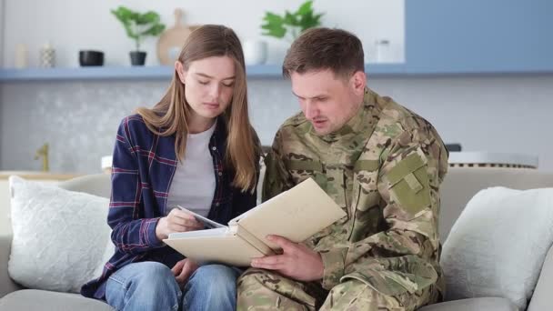 Young Couple Looks Album Photographs Wedding Man Goes Army — Stock Video