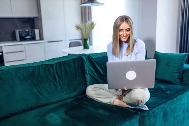 Dizüstü bilgisayarı olan rahat bir kadın kanepede oturur, kız haberleri sosyal ağlardan kontrol eder, arkadaşlarıyla sohbet eder ya da bilgisayarda çalışır, bir blog yazar..