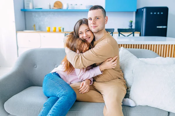 Happy Young Couple Relaxing Cozy Sofa Home Hugging Dreaming Together — Φωτογραφία Αρχείου