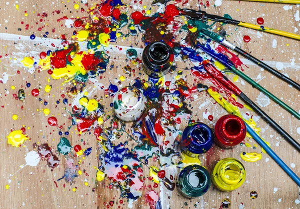 Color bottle and dirty splash on artwork desk — Stock Photo, Image