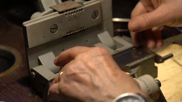 Cinema installer glues the film with scotch tape — Stock Video