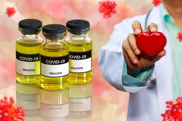 coronavirus Covid-19 Vaccine in bottle for against virus and concept model with doctor holding red heart in hand on water color tone background