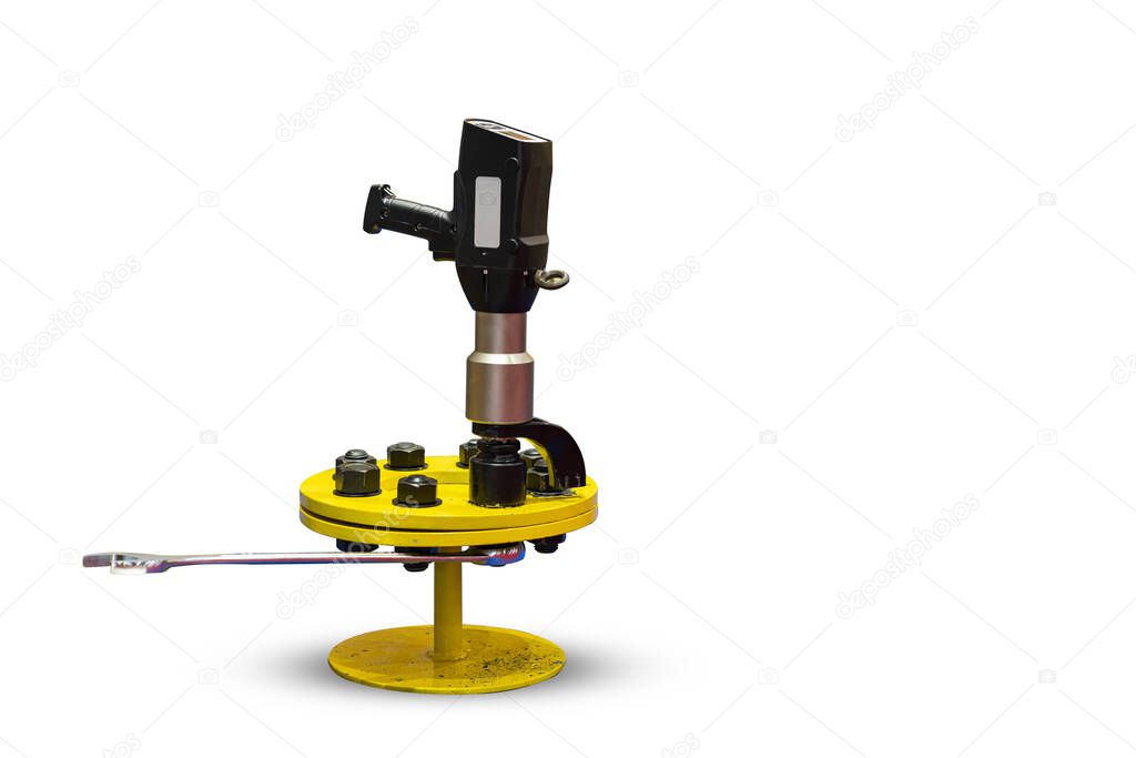 close up digital electric torque wrenches and combination wrench during assembly tighten bolt and nut with work piece on ground isolated with clipping path