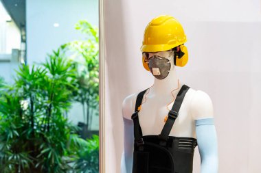 Manikin model operatörü, kask güvenlik maskesi, kol bandı, kulaklık, destek kemeri gibi endüstriyel güvenlik ekipmanları takıyor..