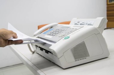 hand man are using a fax machine in the office, equipment for data transmission. clipart