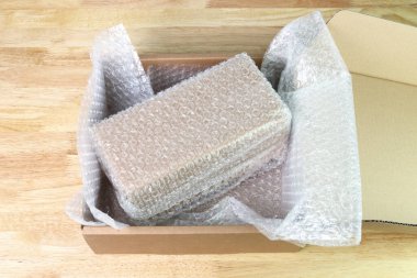 Bubbles covering the box by bubble wrap for protection product cracked  or insurance During transit  clipart