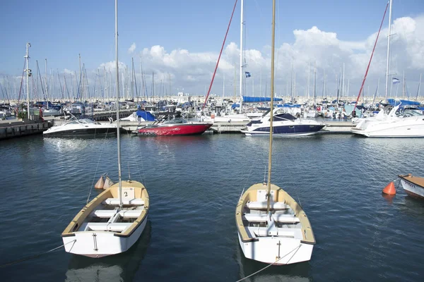 rows of boats and yachts for rent in port