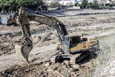 Yeni binaların yakınındaki şantiyedeki büyük kazıcıların bulanık görüntüsü 