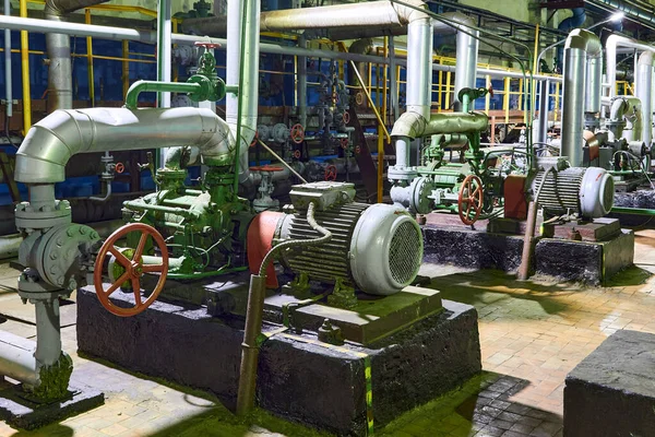 Petrochemical plant interior. Industrial centrifugal pumps of chemical plant or petrochemical plant production system with electric engines valves and pipelines.