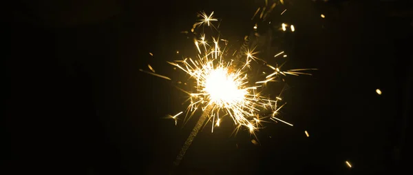 Bnner with burning sparkler on black background — Stock Photo, Image