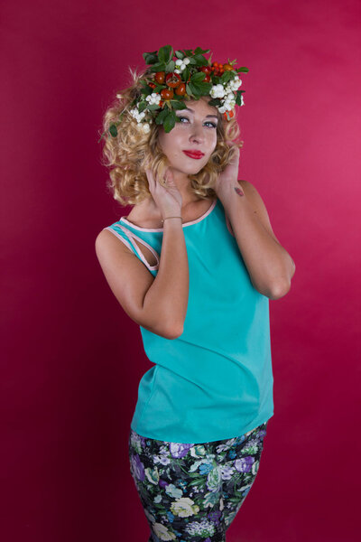 Девушка с осенним венком на красном фоне
