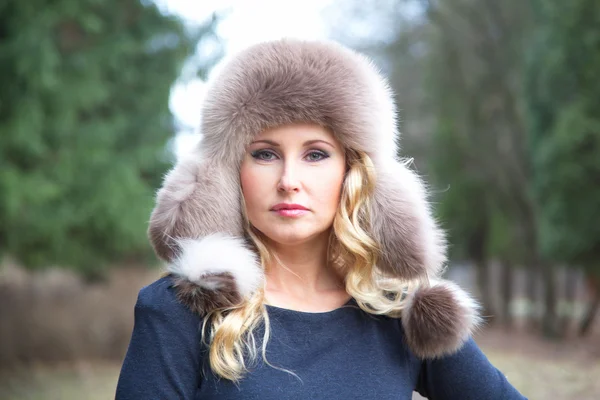 Girl in a fur hat — Stock Photo, Image