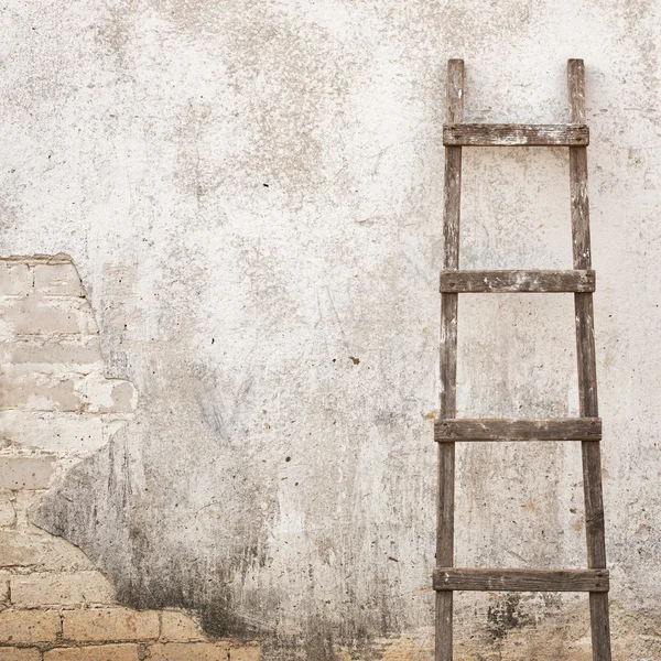 Weathered stucco wall with wooden ladder — Stock Photo, Image