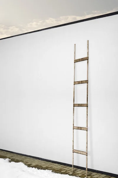 white wall with a wooden ladder