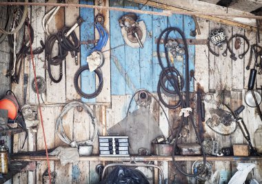 old tools hanging on wooden wall