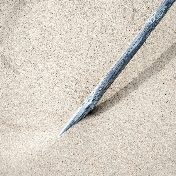 Pole standing in the sand — Stock Photo, Image