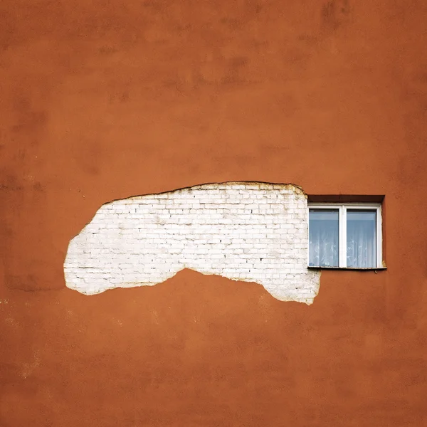 Abandoned cracked brick  wall with a window — Stock Photo, Image